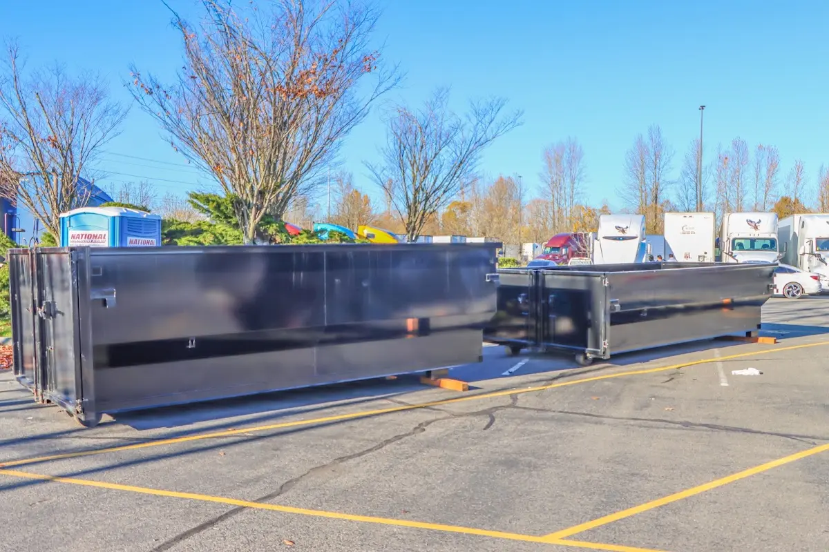 Professional dumpster rental service with roll-off container on residential driveway in Suamico